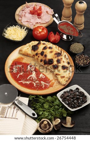 Studio shot of pizza Calzone and ingredients