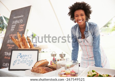 Female Bakery Stall Holder At Farmers Fresh Food Market Royalty-Free Stock Photo #267549521