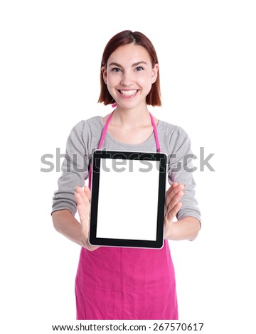Happy young woman housewife Wearing Kitchen Apron and show digitablet pc isolated Over White Background, caucasian beauty