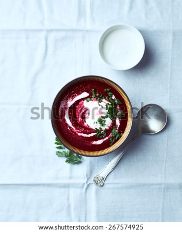 Cream of beetroot soup with cream and fresh parsley
