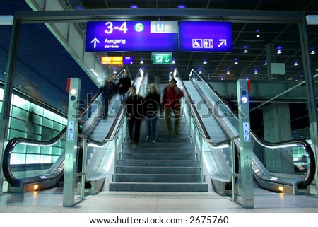 people descending escalators and stairs