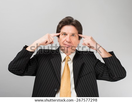 businessman fingers to his temple
