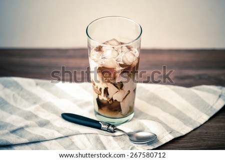Ice coffee with cream in glass. Toned picture