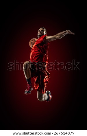 Isolated on black basketball player in action is flying high 