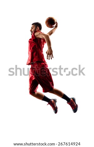 Isolated on white basketball player in action is flying high  Royalty-Free Stock Photo #267614924