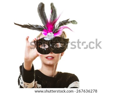 Holidays, people and celebration concept. Woman having fun trying carnival venetian mask on white background