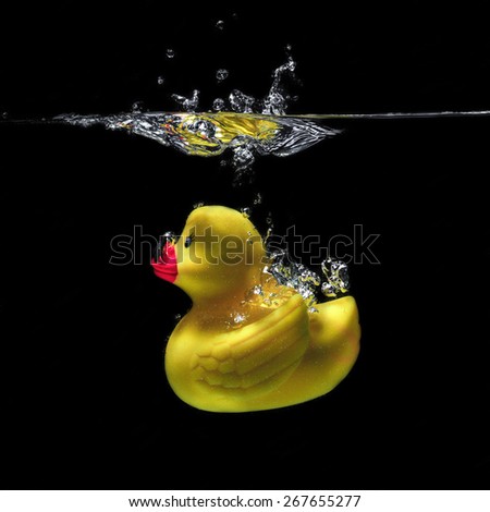 Rubber duck bath under water on a black background