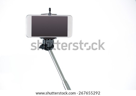 Smartphone on a selfie stick shot in studio Royalty-Free Stock Photo #267655292