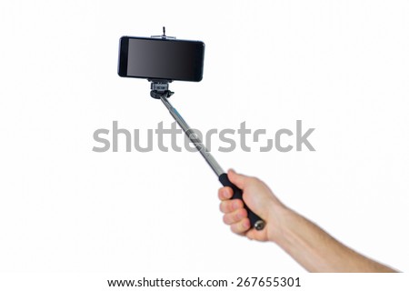 Man using a selfie stick shot in studio Royalty-Free Stock Photo #267655301