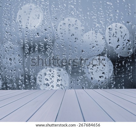 Empty table with blurred, window, rain drops  background, for product display template