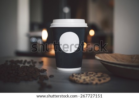 Blank paper cup of coffee in a coffee shop for the application logo Royalty-Free Stock Photo #267727151