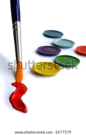 Paint brush, red paint,  and paint pallet closeup