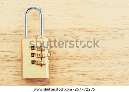 Key pad lock on wooden background process vintage style picture
