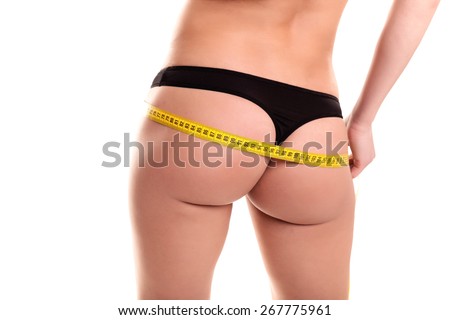 Young Woman measuring her waist - Stock Image