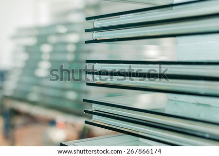 Sheets of Factory manufacturing tempered clear float glass panels cut to size Royalty-Free Stock Photo #267866174