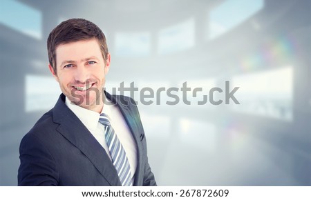 Businessman smiling and offering his hand against bright white room with windows