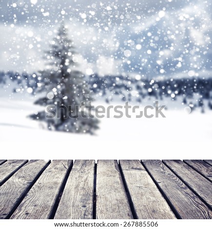 winter background with individual tree and cloudy sky with snowflakes
