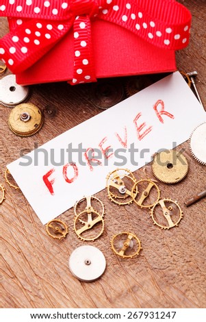 Red gift box tied red ribbon and text "Forever"