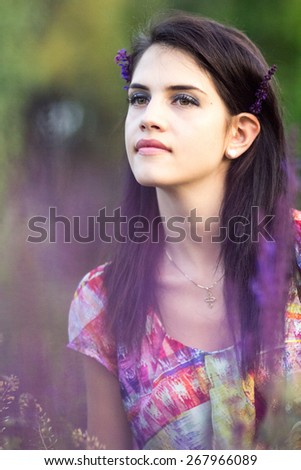 Beautiful girl posing in the park. Image has grain texture visible on maximum size