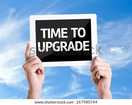 Tablet pc with text Time To Upgrade with sky background