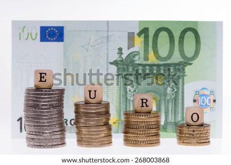 Money stack and wood dice with the word Euro / Euro Money