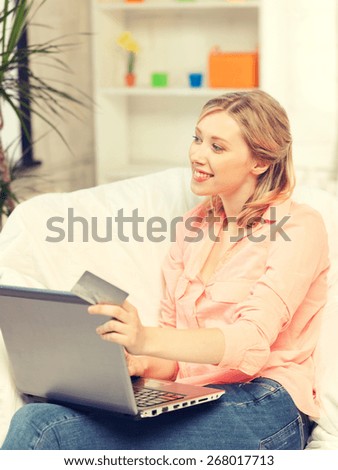 picture of happy woman with laptop computer and credit card..
