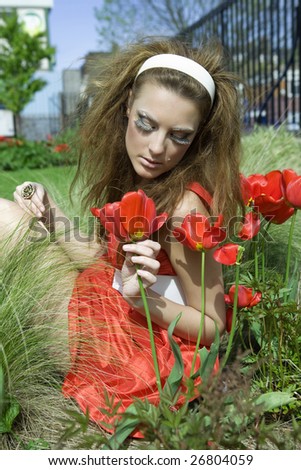  girl sitting in grass and flowers