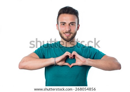 smiling young boy making heart gesture on his chest with green shirt isolated on white background