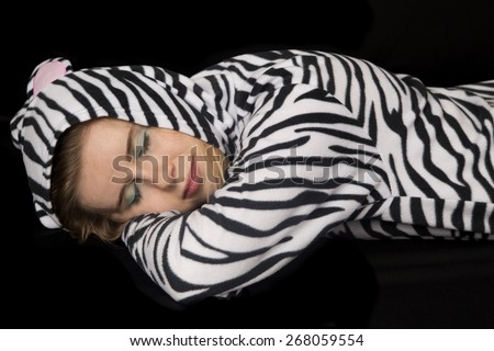 Woman laying down wearing cat pajamas asleep