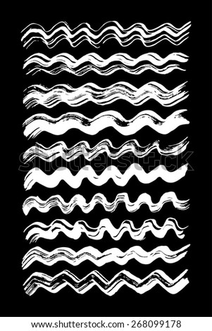 Paint brush strokes collection. Set of vector paint brush strokes. White design elements. EPS10 white vector elements isolated on black.