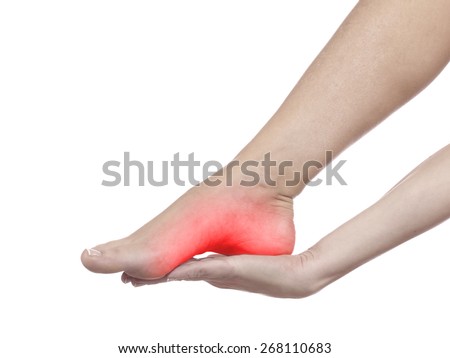 A young woman massaging her painful ankle. Medicine concept photo.