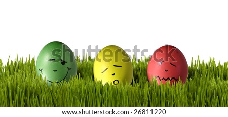 three color eggs with different face in grass for eastern
