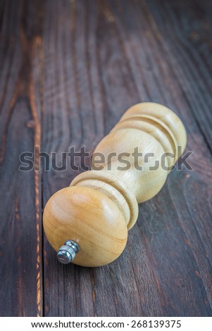 Pepper shaker on wooden background - old dark effect style pictures