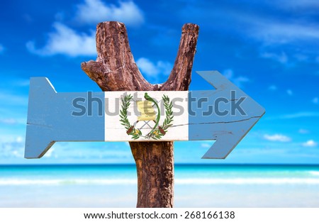 Guatemala Flag wooden sign with beach background