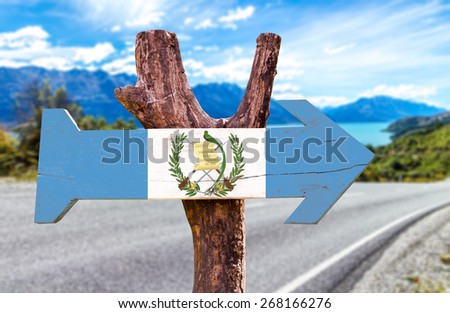 Guatemala Flag wooden sign with road background