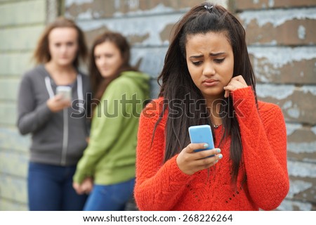 Teenage Girl Being Bullied By Text Message Royalty-Free Stock Photo #268226264