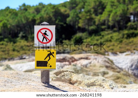A sign indicating not to trespass and danger of falling