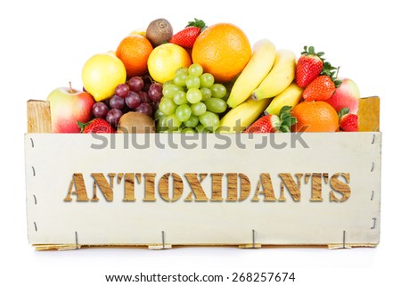 Antioxidants. Fruits in wooden box  Royalty-Free Stock Photo #268257674