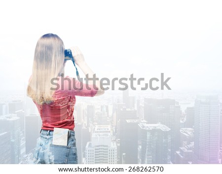 Young tourist woman is taking the picture of New York city