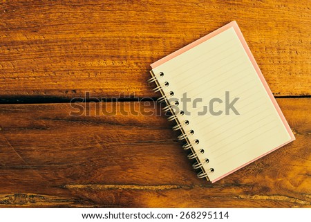 Note book on wooden background - vintage effect style pictures