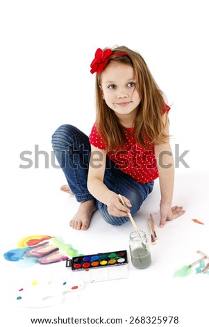 Little girl painting with watercolors