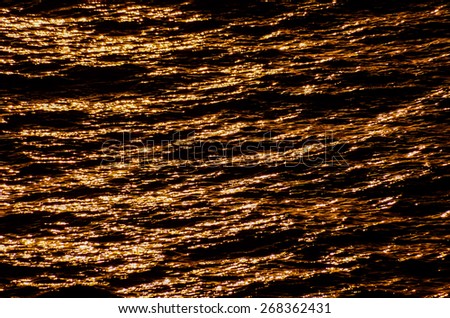 Orange Still Sea Water With Ripple. Natural Background Photo Texture