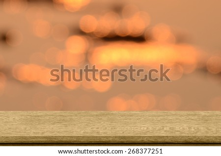 Old wood shelf with sunset and bokeh background.