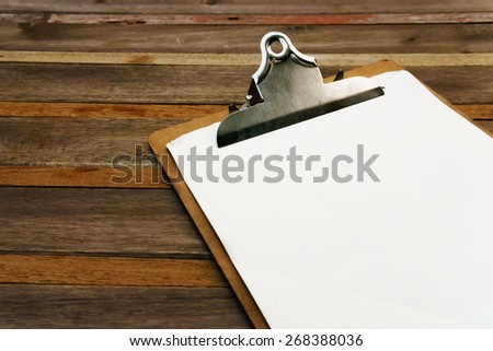 Blank clip on menu on wooden background Royalty-Free Stock Photo #268388036