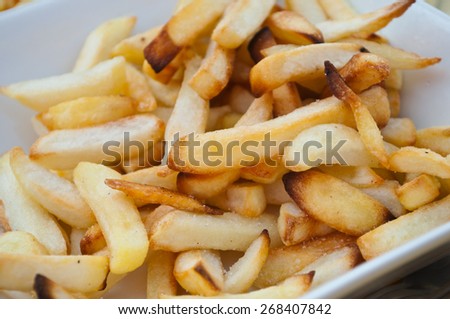 french fries closeup on a white plate
