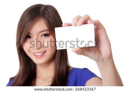 Beautiful young Asian woman smiling and showing blank business card, on white background