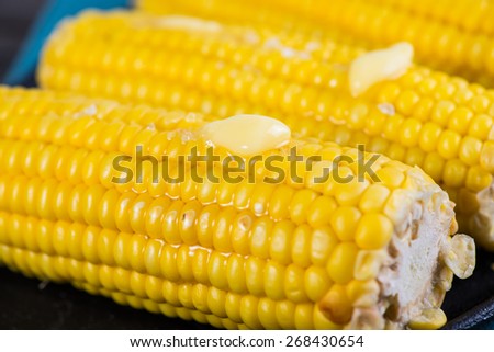 close view on Homemade golden corn cob with butter and salt on table