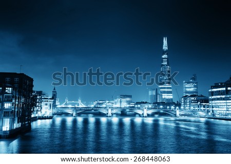 Southwark Bridge and London skyline at night.