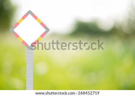 Wooden sign on nature green blurred background with bokeh.