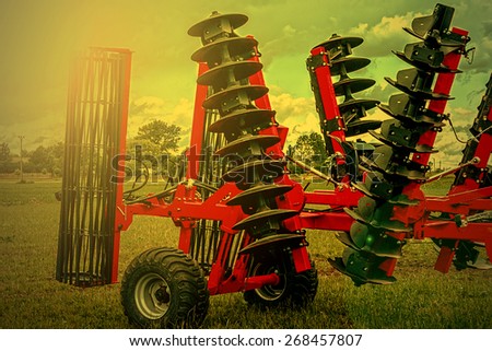 Agricultural equipment in sunset light. Image digitally manipulated.